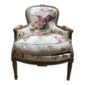 Reupholstered bergère with floral fabric in Louis XVI style.