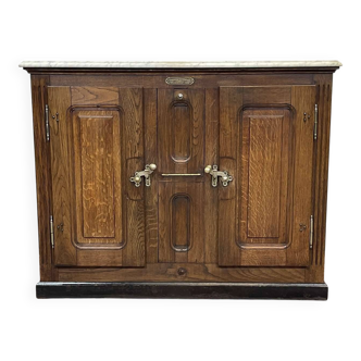 Icebox from the early 20th century in oak with a marble top.