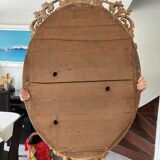 Beveled oval mirror in wood and stucco
