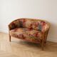 Two-seater banquette in Louis XV style made of wood and floral fabric.