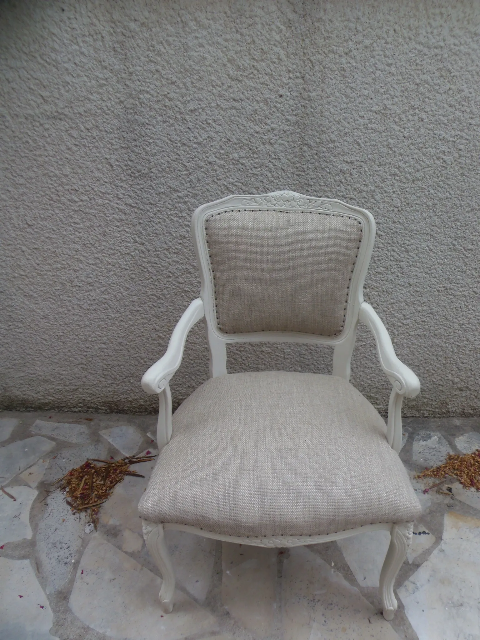 Louis XV style armchair, delicately patinated in a soft beige hue.