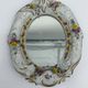 Antique porcelain mirror from Dresden with relief flowers and rococo decoration.