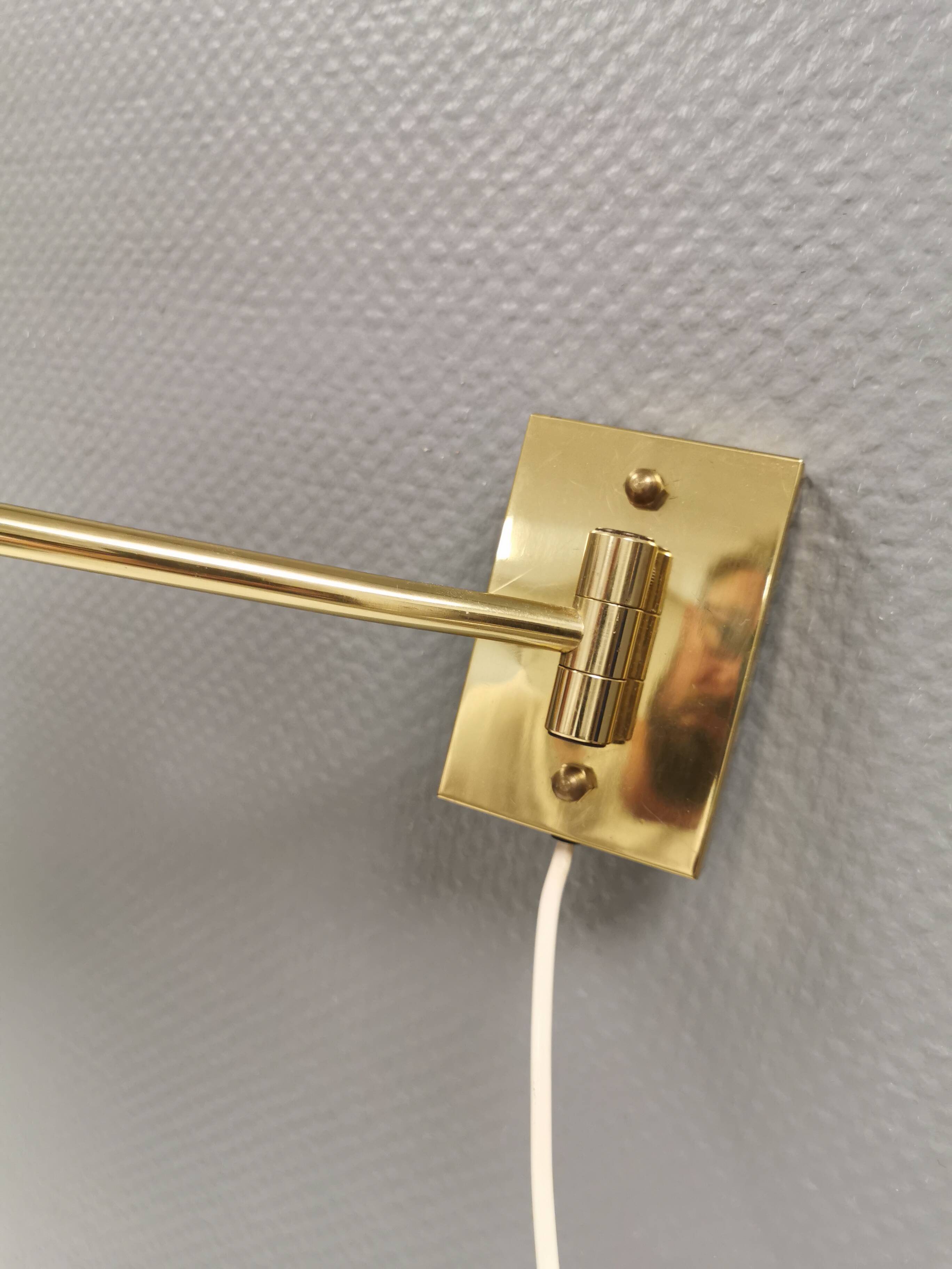 Danish Brass wall lamp with a ‘swivel’ effect.