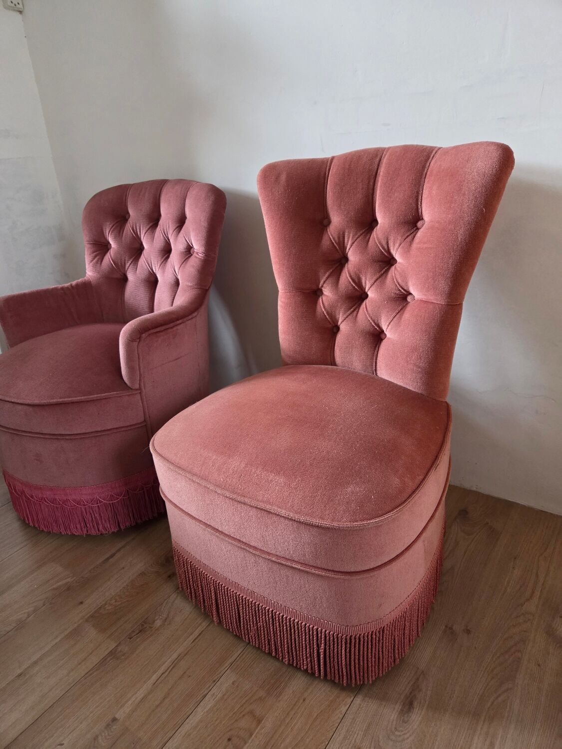 A pair of small tub chairs.