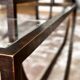 Asymmetrical metal-and-glass coffee table with curved architectural frame.