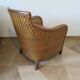 Colonial style armchair in woven rattan and exotic wood