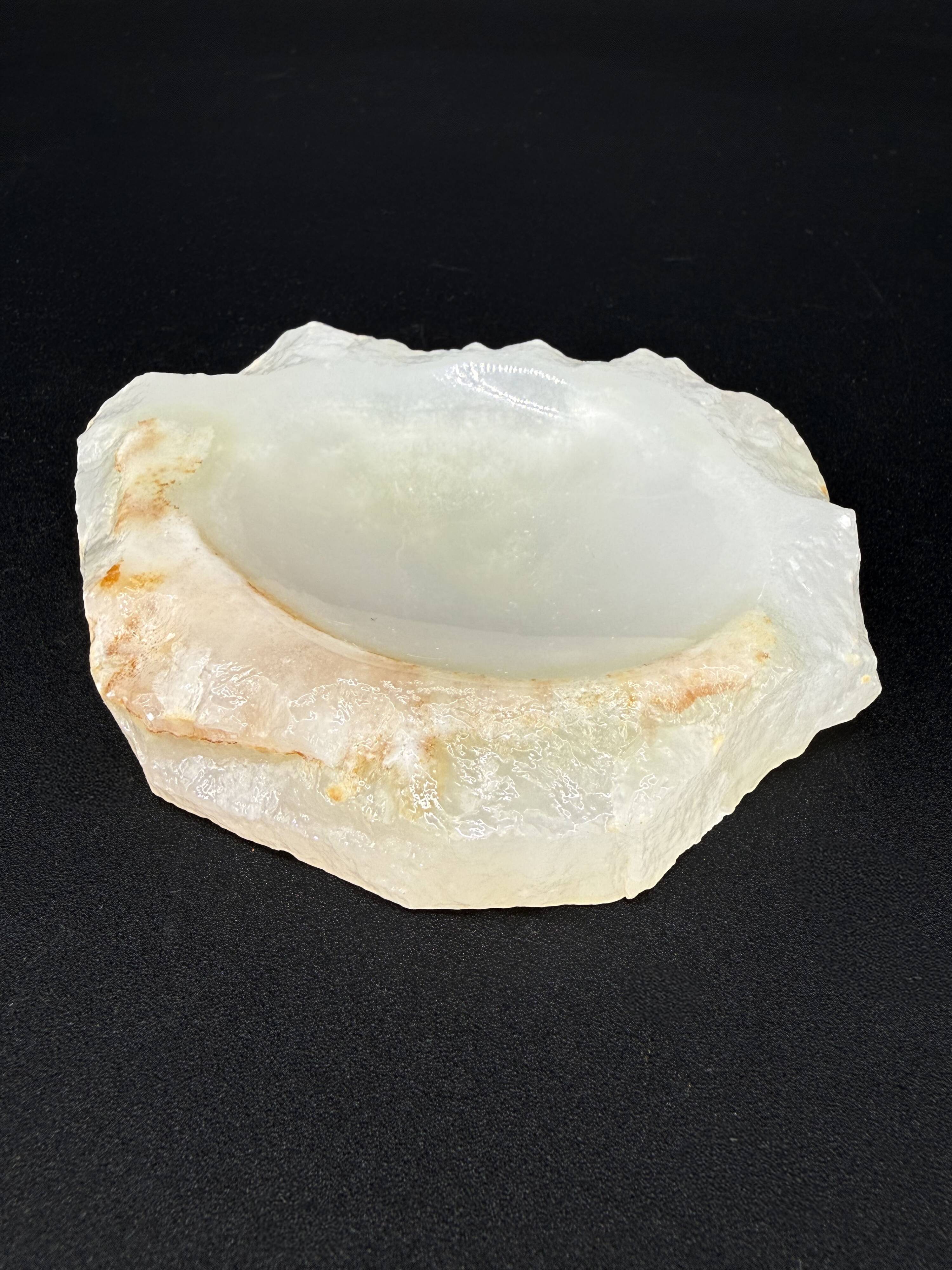 Empty pocket bowl made of translucent natural stone.