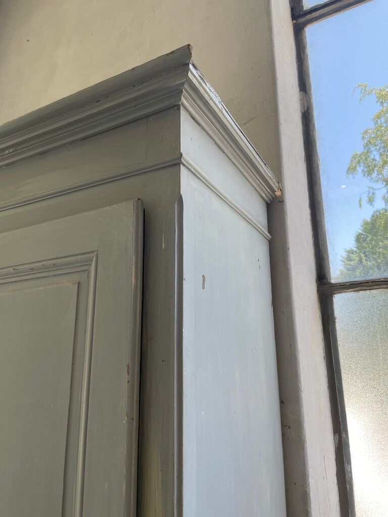 Blue patinated cap cabinet