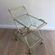 Italian designer rolling table in brass and engraved glass