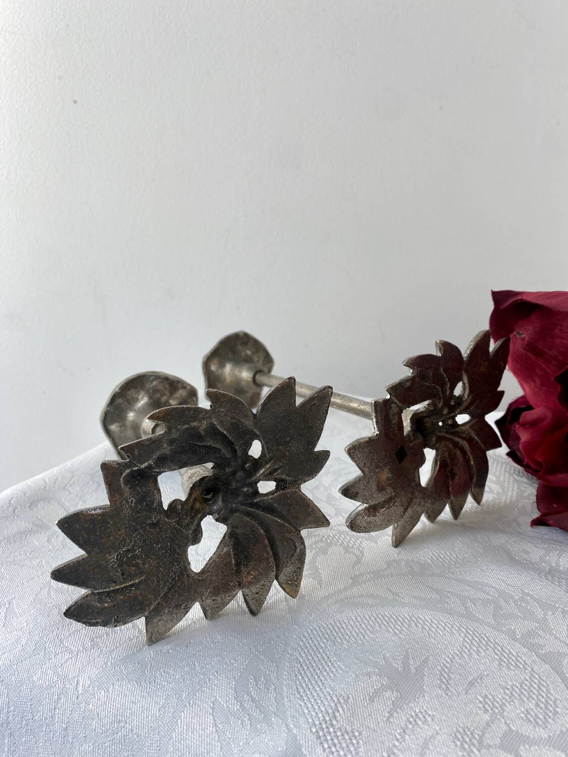 Pair of metal flower candlesticks