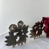 Pair of metal flower candlesticks