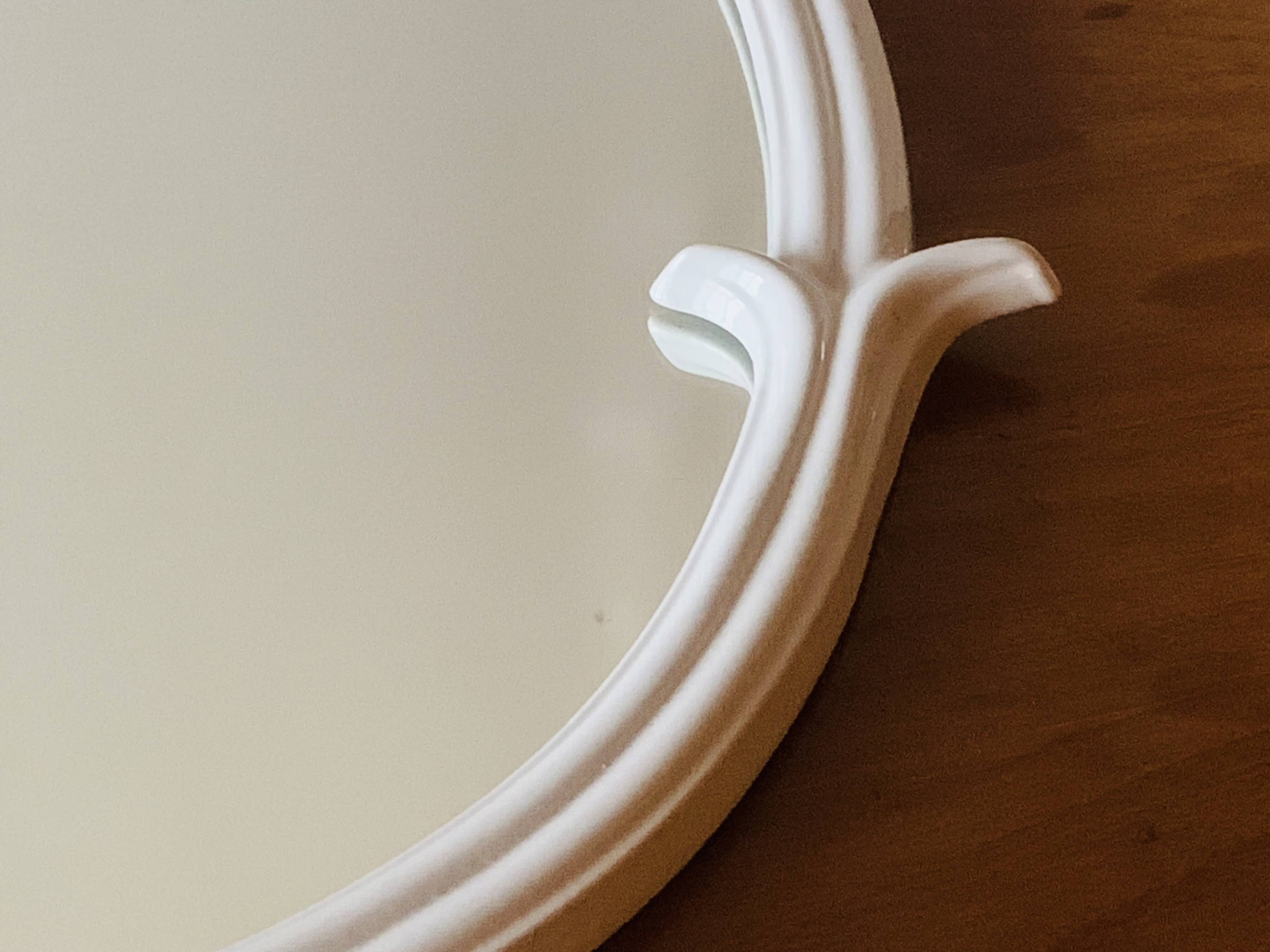 Oval mirror in vintage enameled white cast iron