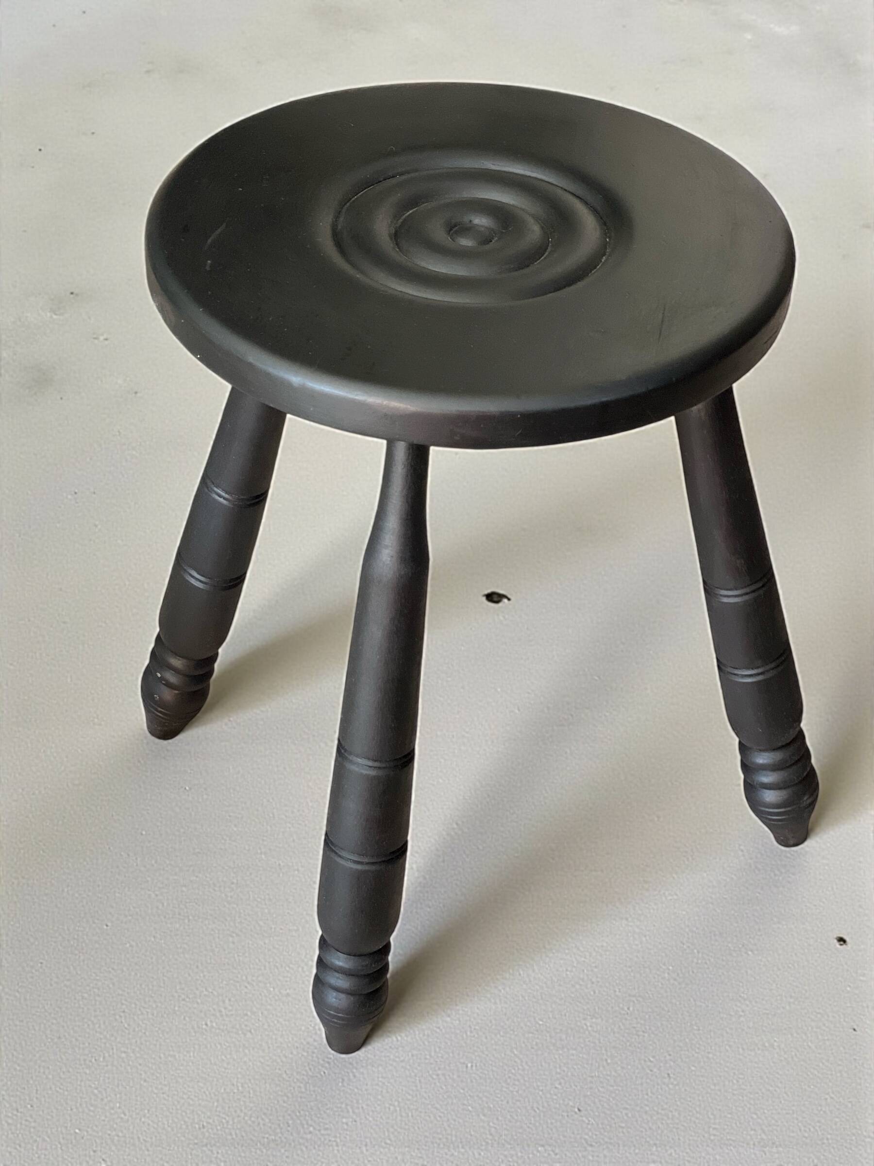 Set of side table and 2 stools, stained black wood, Circa 1950.