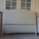 Louis XV style headboard with pearl grey patina, upholstered in off-white bouclette.