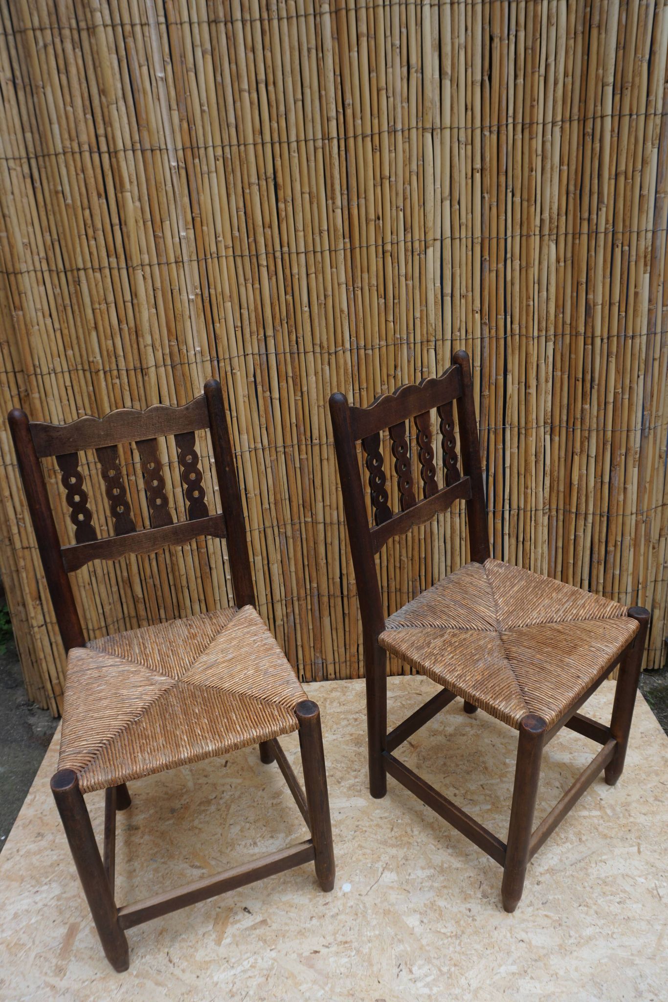 Pair of antique straw-seated farm chairs