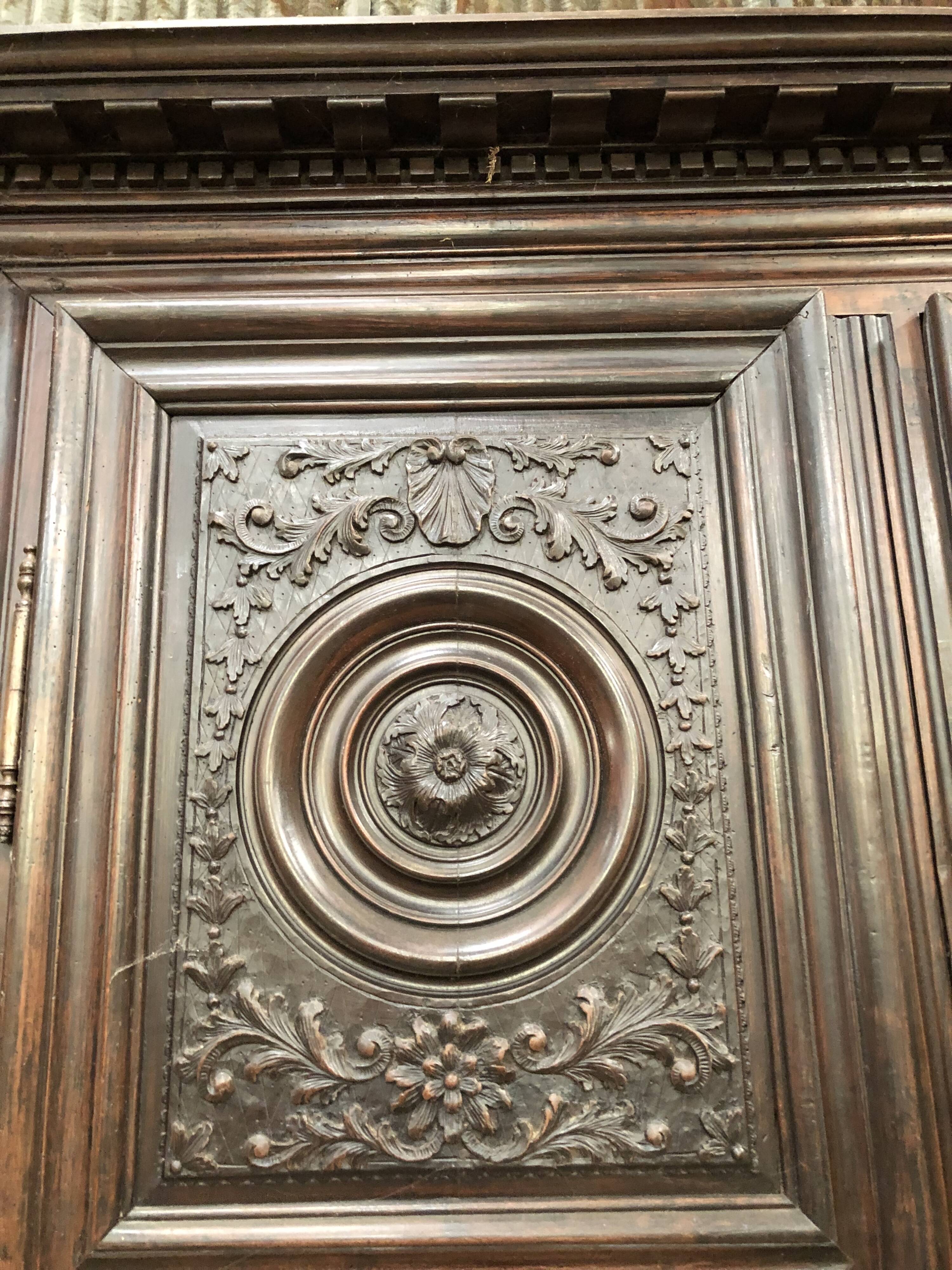 Antique Louis XIII armoire in solid walnut with carved doors