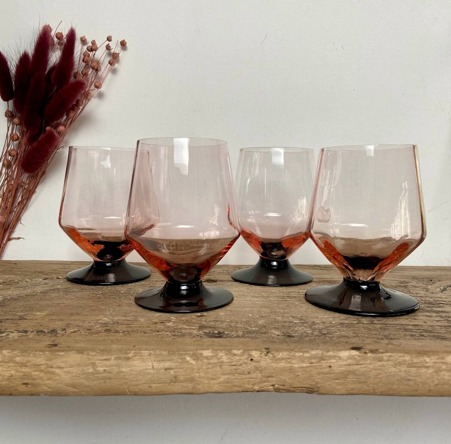 4 pink glasses with black stem