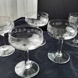 8 vintage glass champagne coupes with an engraved frieze decoration.
