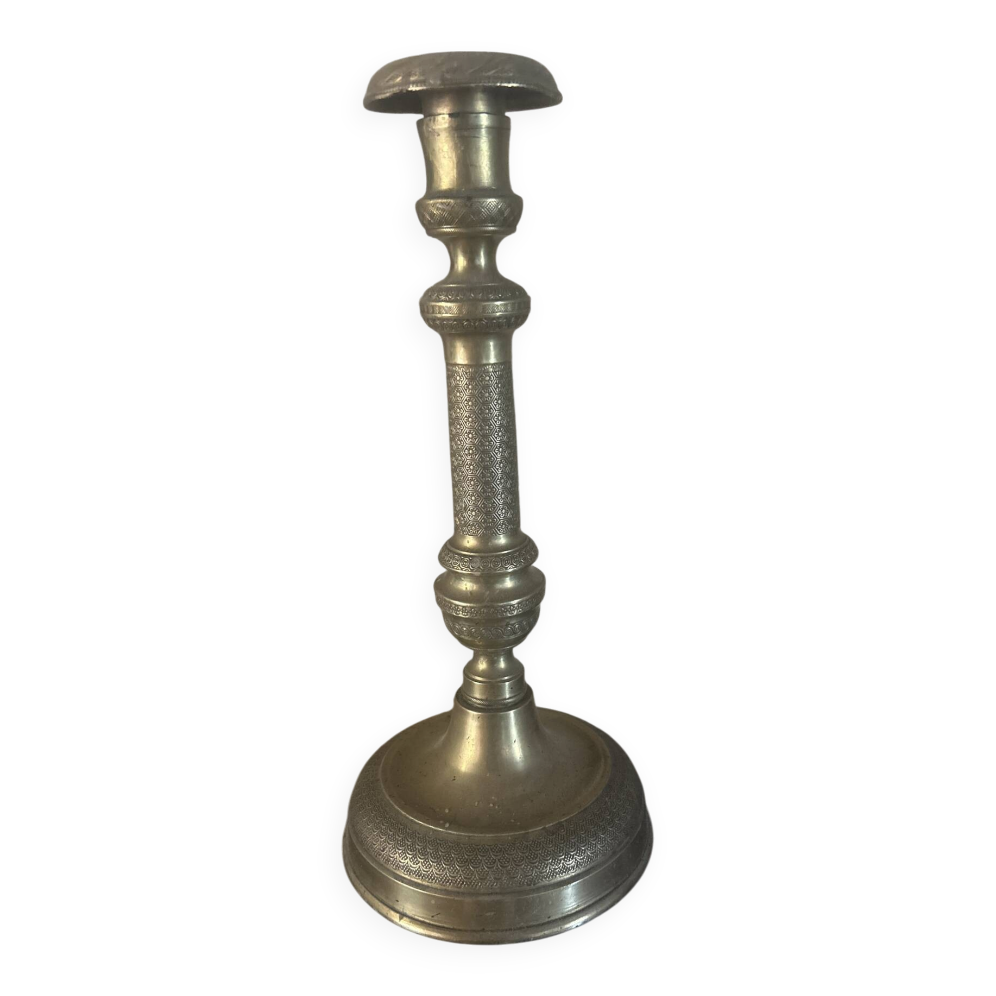 Large antique brass candlestick with floral decoration.