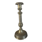Large antique brass candlestick with floral decoration.