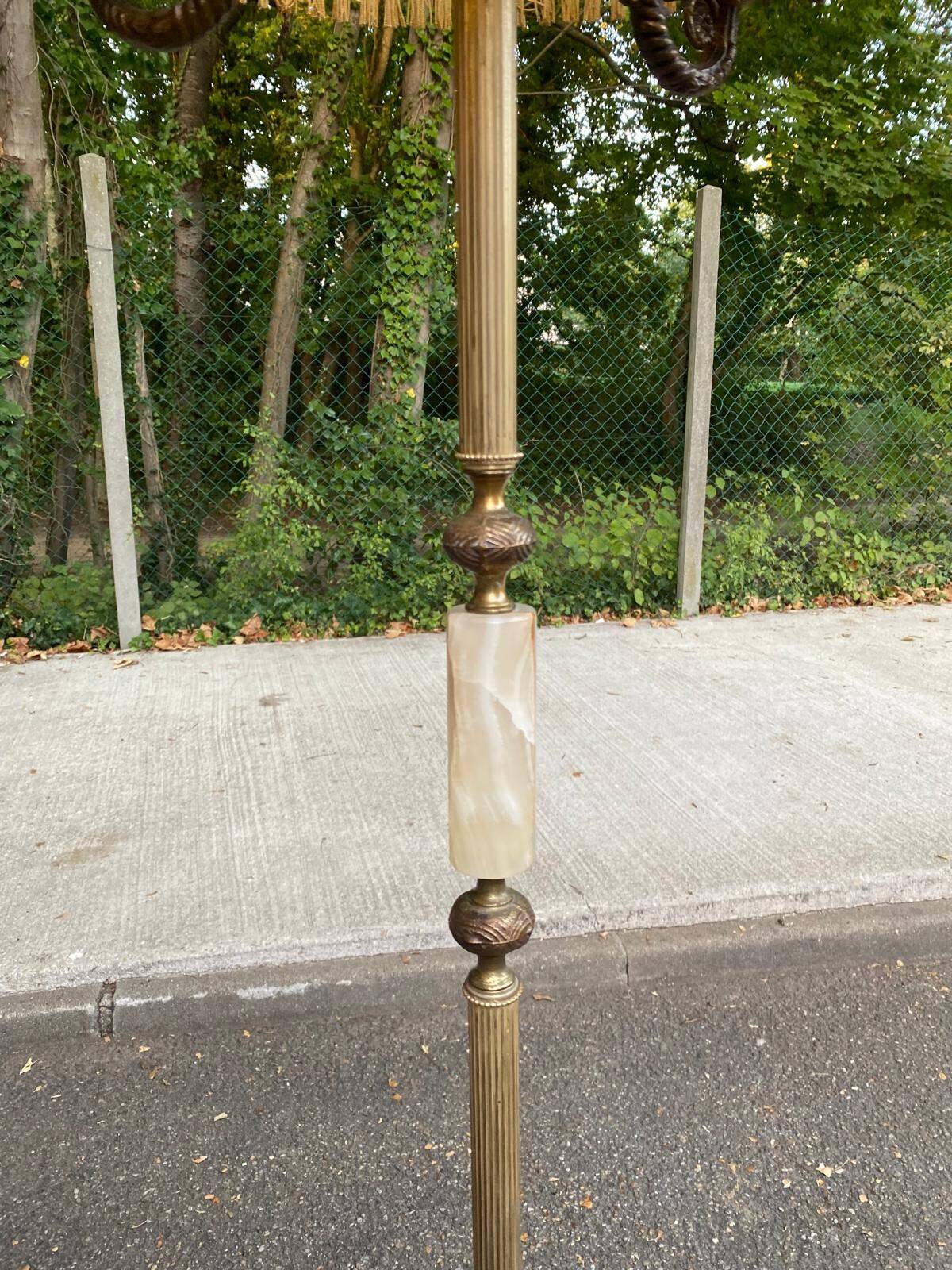 Vintage brass onyx floor lamp with fringed shade.
