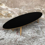 Oval coffee table with a black tray and oak-turned feet