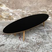 Oval coffee table with a black tray and oak-turned feet