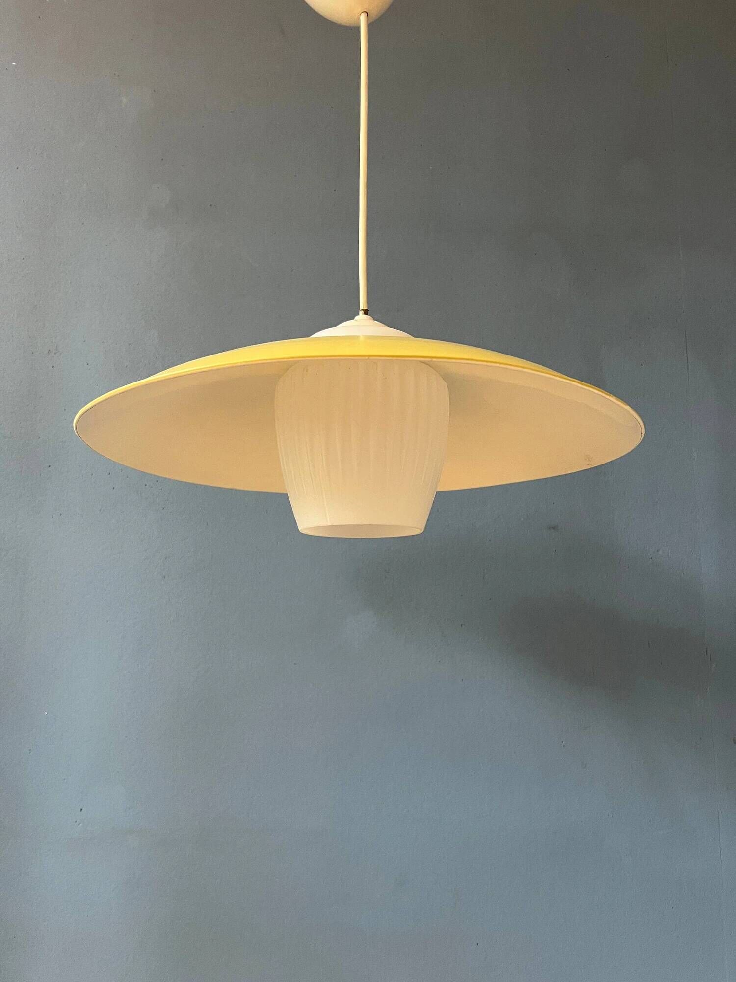 Danish mid-century suspension with opaline glass shade and yellow metal cover.