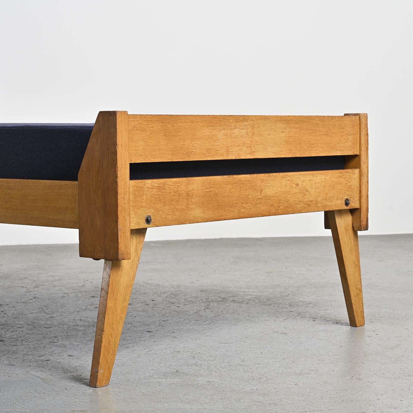 Wooden bench with midnight blue fabric, France, circa 1955