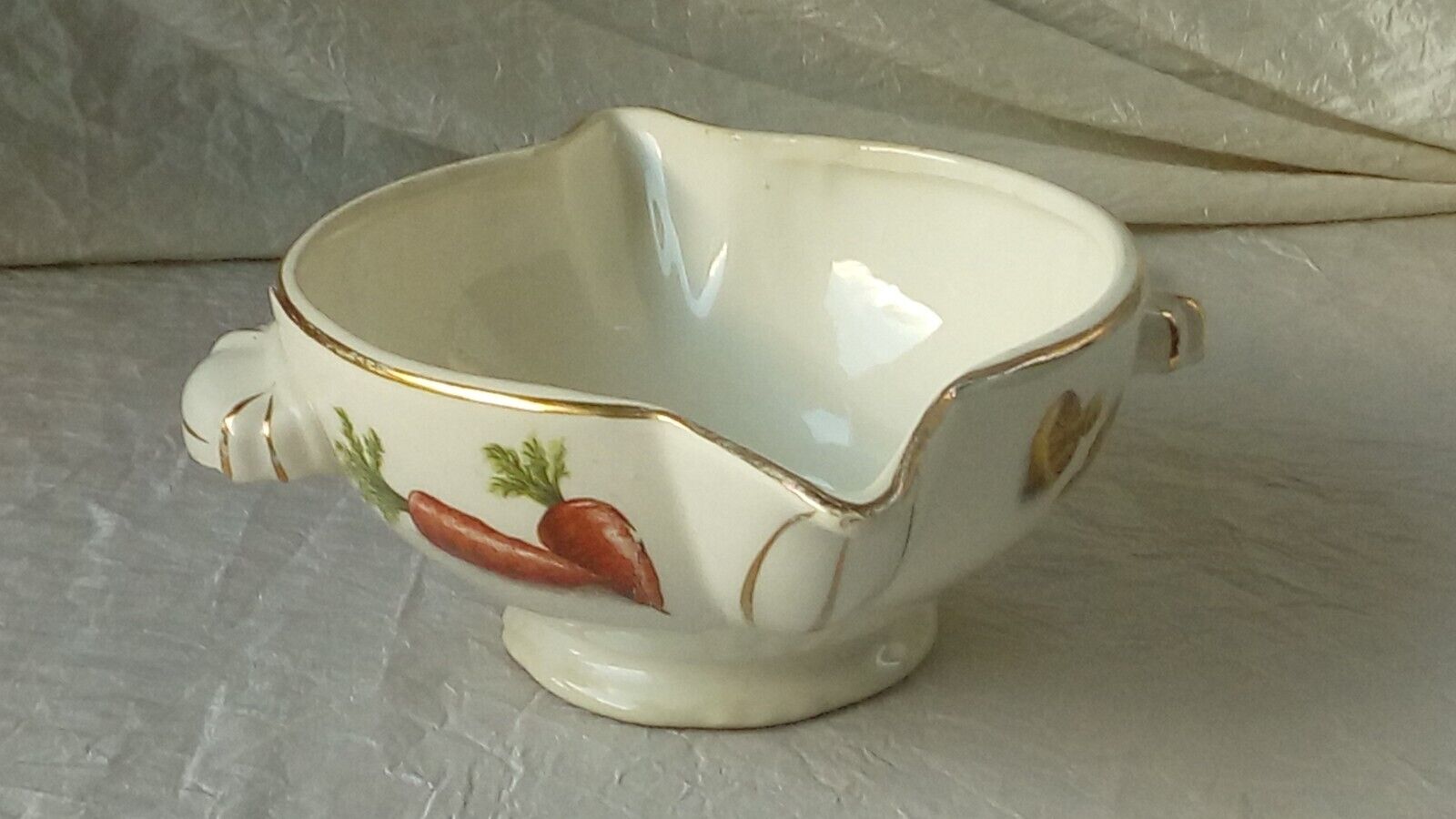 Sauceboat in earthenware decorated with four seasons vegetables.