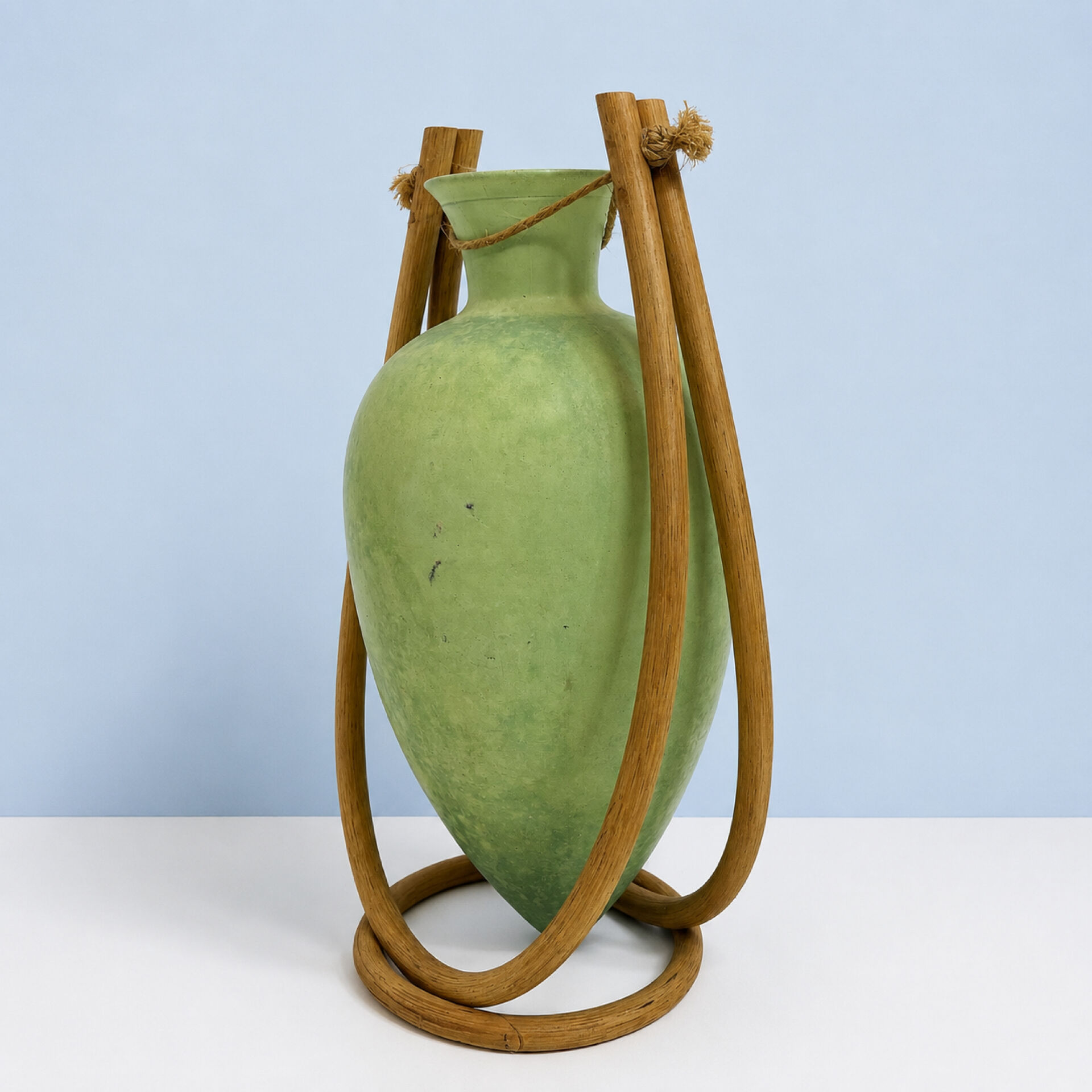 Rare glass paste amphora suspended in a wicker frame.