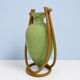 Rare glass paste amphora suspended in a wicker frame.