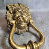 Gilded bronze door knocker in the shape of a lion's head