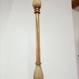 Bronze floor lamp with pine cone decoration.