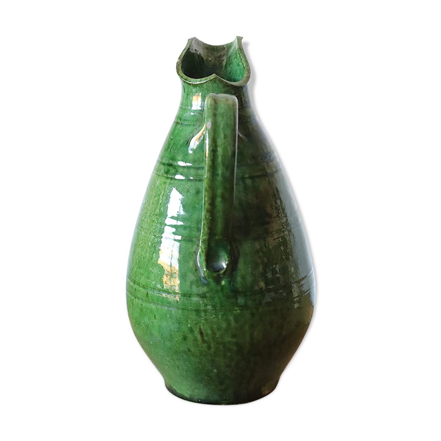 Green old pitcher in glazed terracotta