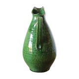 Green old pitcher in glazed terracotta