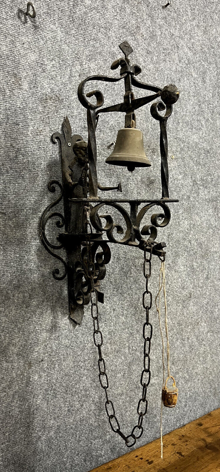 Wrought iron entrance bell depicting a monk ringing a bell circa 1900-1930