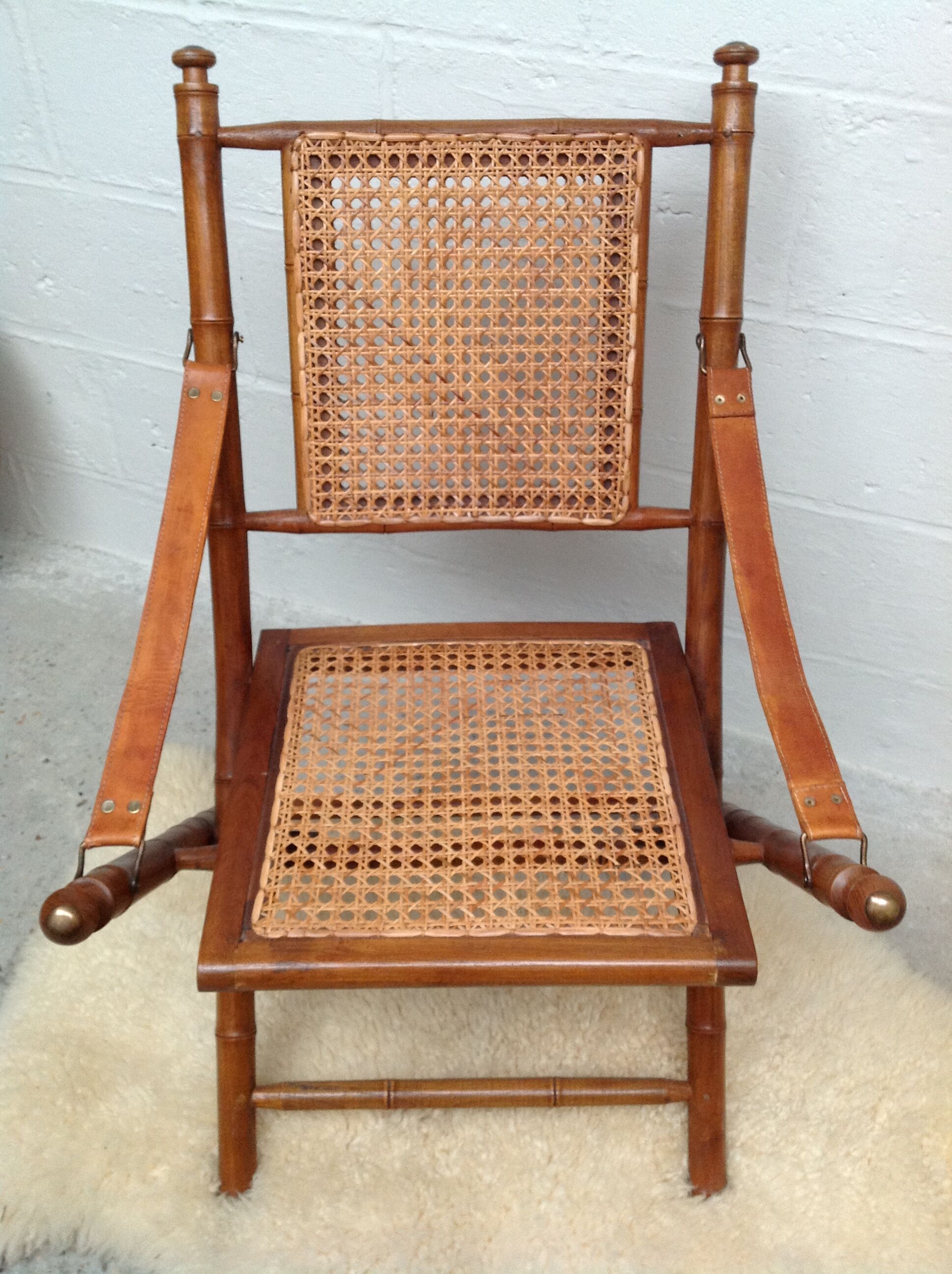 Bamboo folding armchair and caning, leather and brass