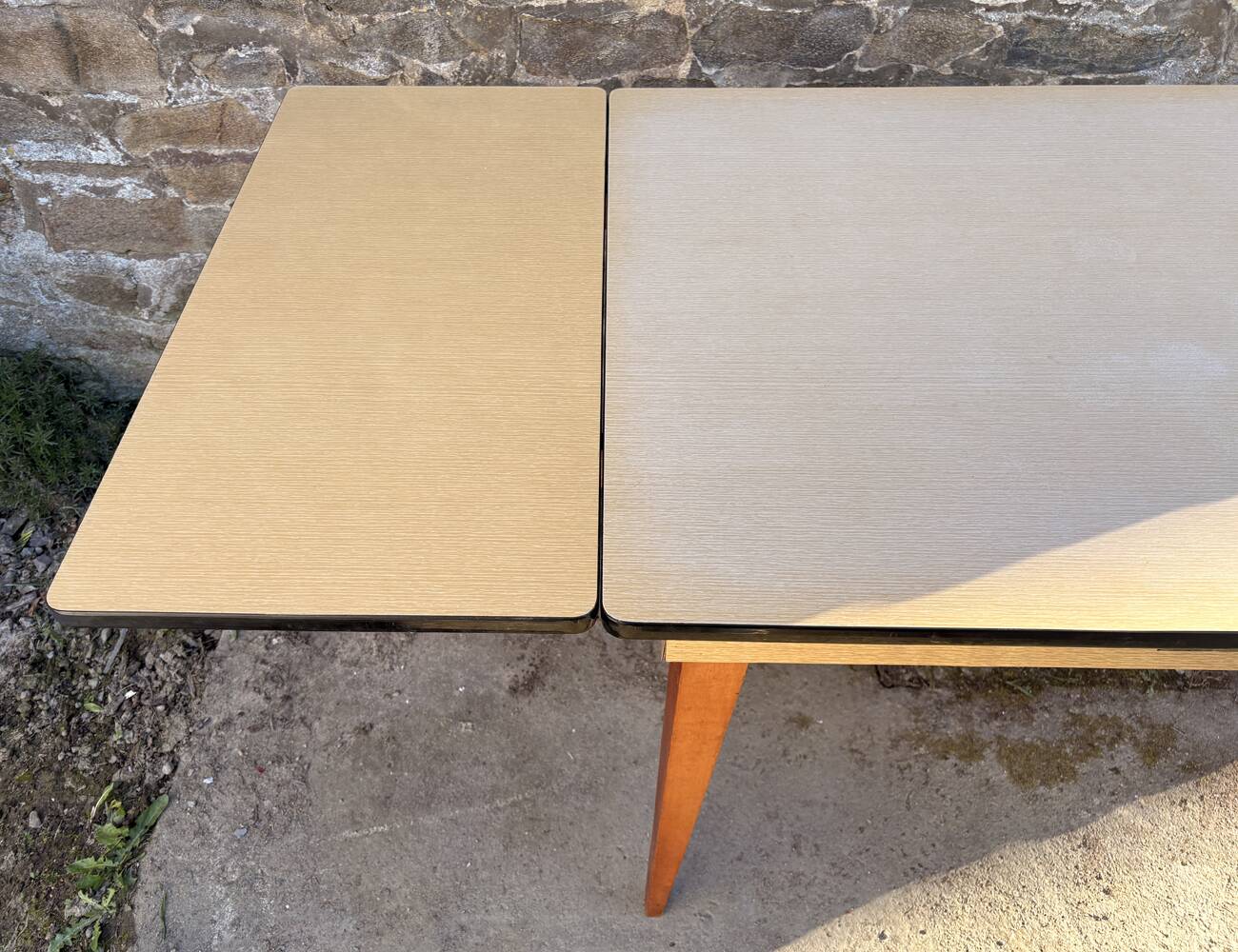 Beige French modernist extendable table, wooden legs, circa 1955.
