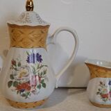 Golden porcelain teapot and coffee pot set with floral design and matching milk jug.