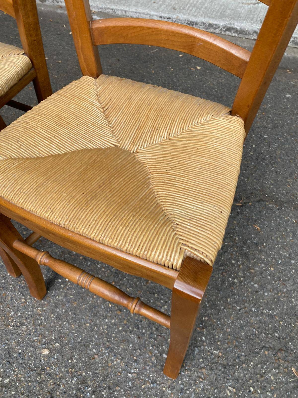 2 wooden dining chairs with rush seats from the 1970s.