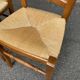 2 wooden dining chairs with rush seats from the 1970s.