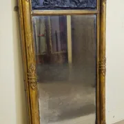 Large antique gilded wooden mirror with terracotta relief from the Empire period.