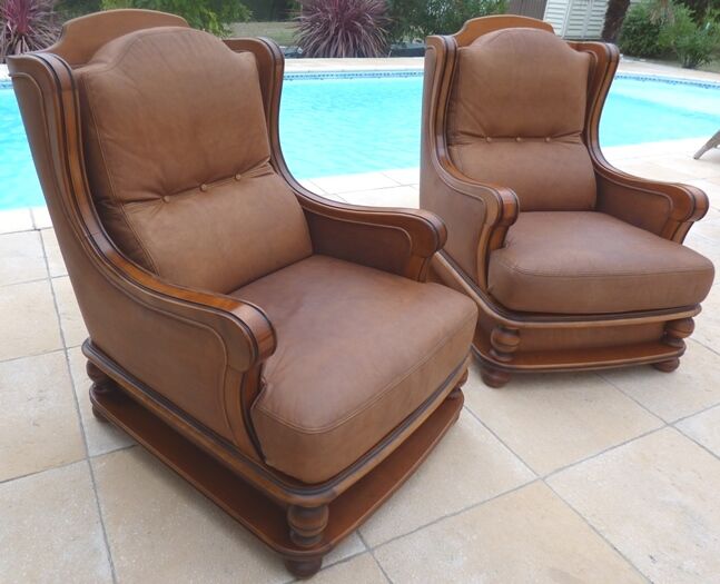 Pair of aged leather armchairs with seat and firm backrest with cherry wood frame