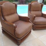 Pair of aged leather armchairs with seat and firm backrest with cherry wood frame