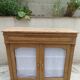 Antique wooden sideboard, fabric doors and pearl grey shelves.