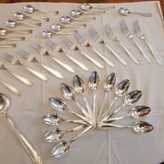 Silver cutlery set for 36 place settings and its ladle.