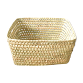 Storage basket in braided palm leaves