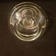 Round glass candle holder with silver-plated metal spiral.