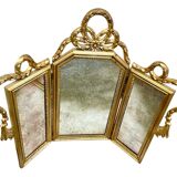 Triptych-shaped mirror in gilded wood and carved with a frieze